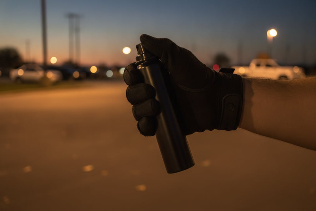 OC pepper spray canister held in a low ready position
