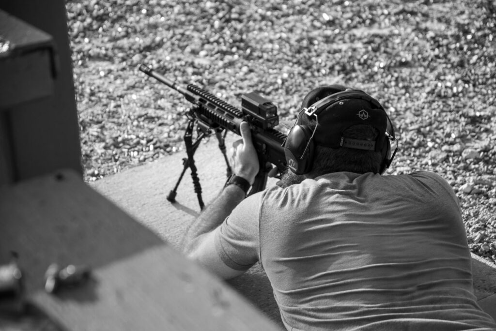 Student firing a rifle from the prone position on the range